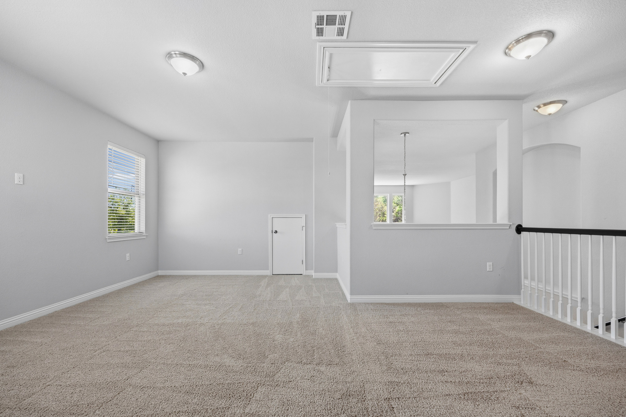 2209 Littleleaf Lane Leander, TX 78641 - Photo 18 of 27 Spare room with light colored carpet and healthy amount of natural light