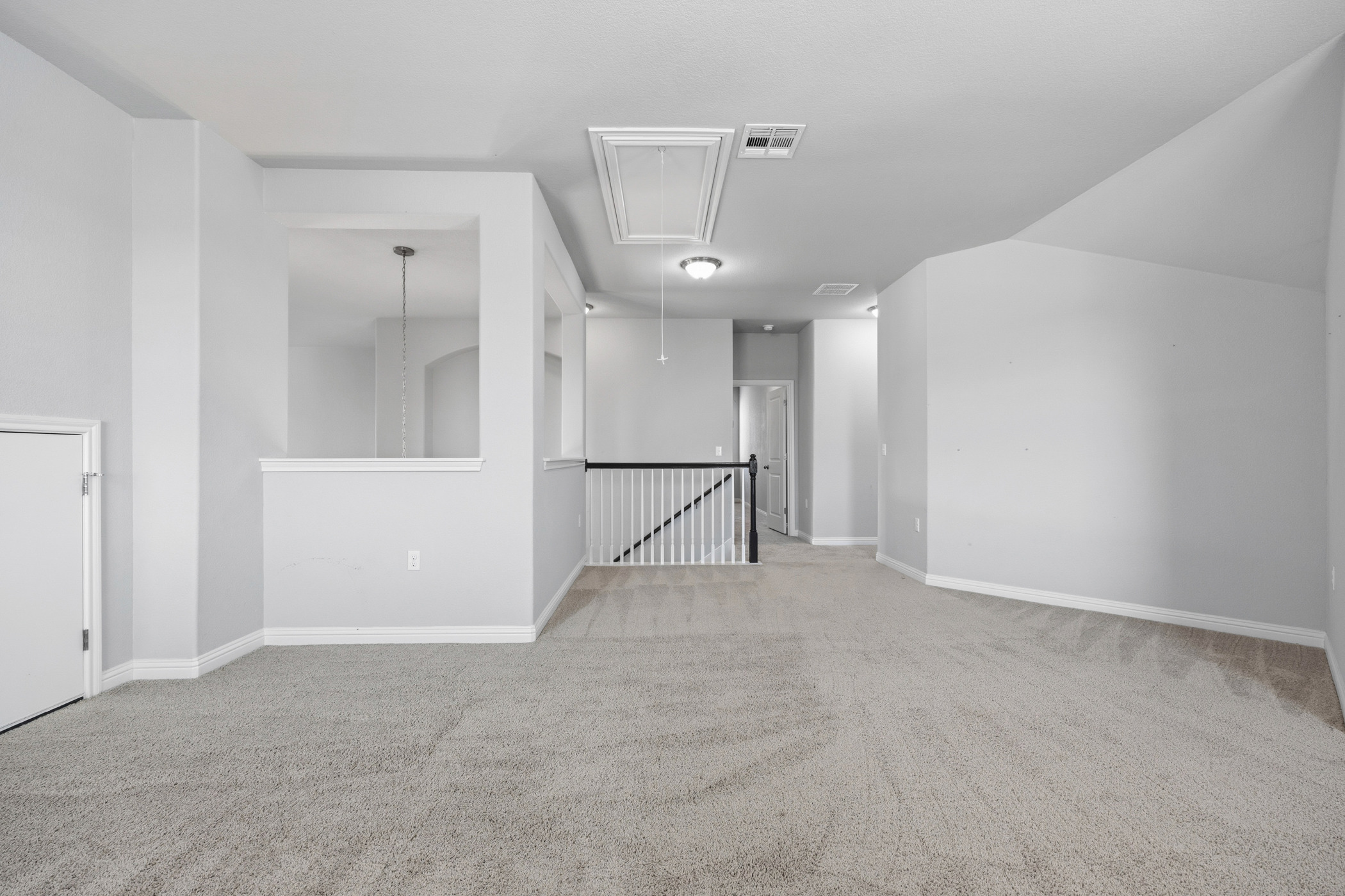 2209 Littleleaf Lane Leander, TX 78641 - Photo 19 of 27 Unfurnished room with light carpet and vaulted ceiling
