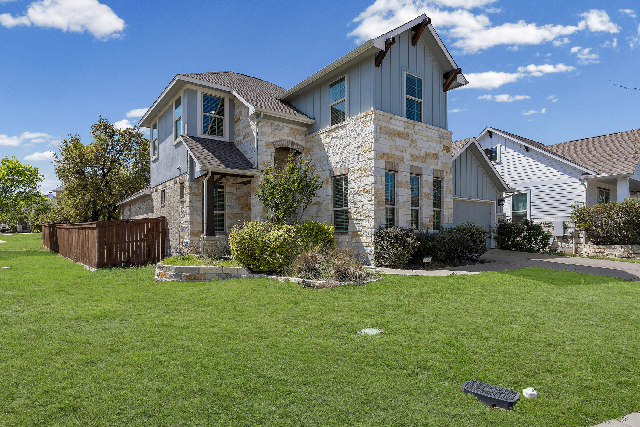 2209 Littleleaf Lane Leander, TX 78641 - Photo 2 of 27 View of front of home with board and batten siding, stone siding, roof with shingles, and driveway