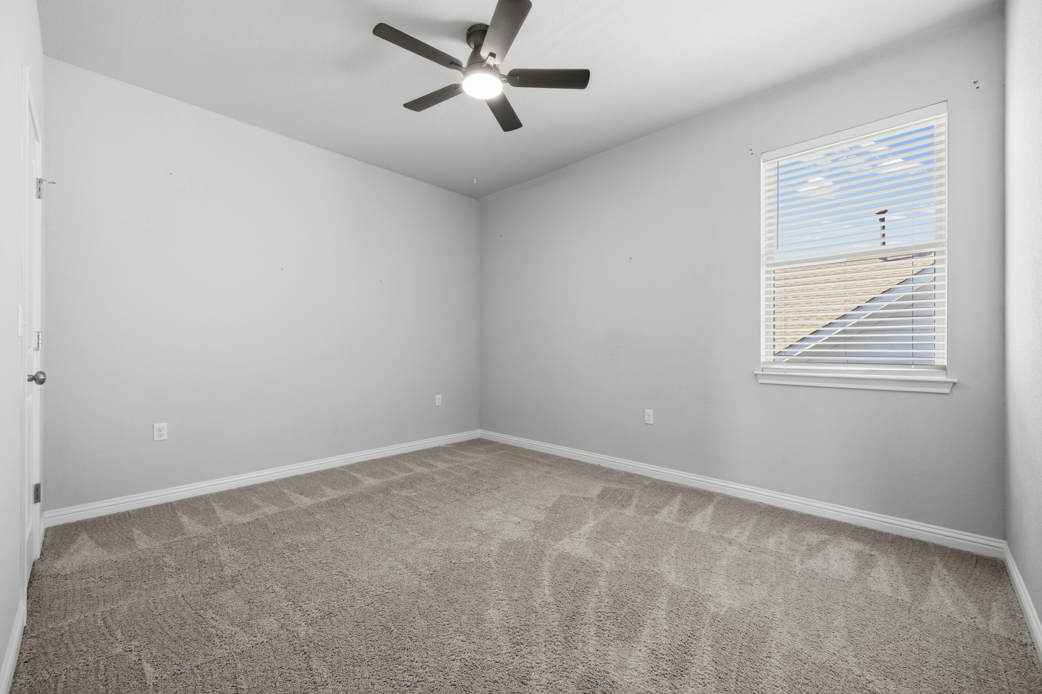 2209 Littleleaf Lane Leander, TX 78641 - Photo 21 of 27 Unfurnished room with light colored carpet and a ceiling fan