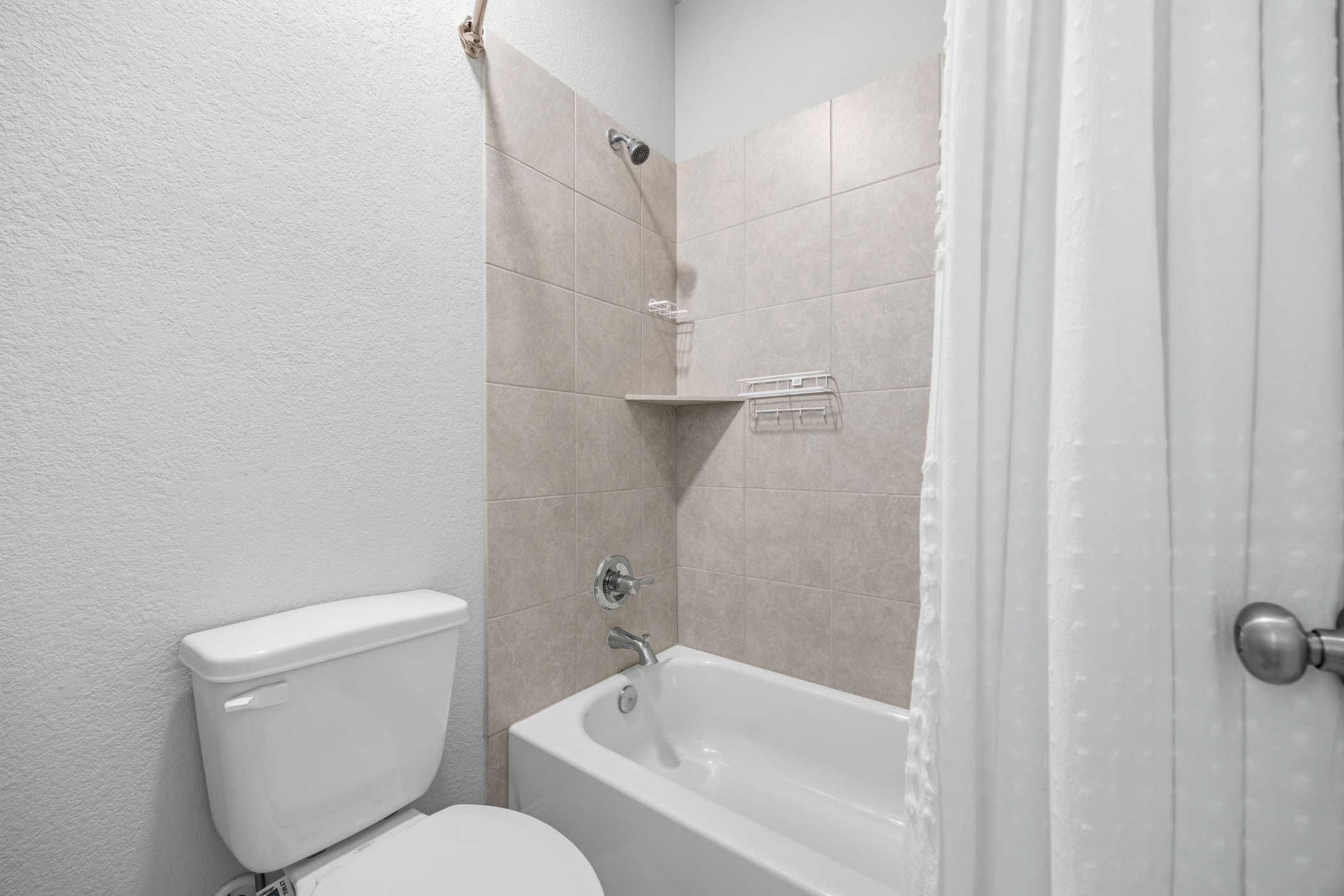 2209 Littleleaf Lane Leander, TX 78641 - Photo 23 of 27 Bathroom with a textured wall and shower / bath combo