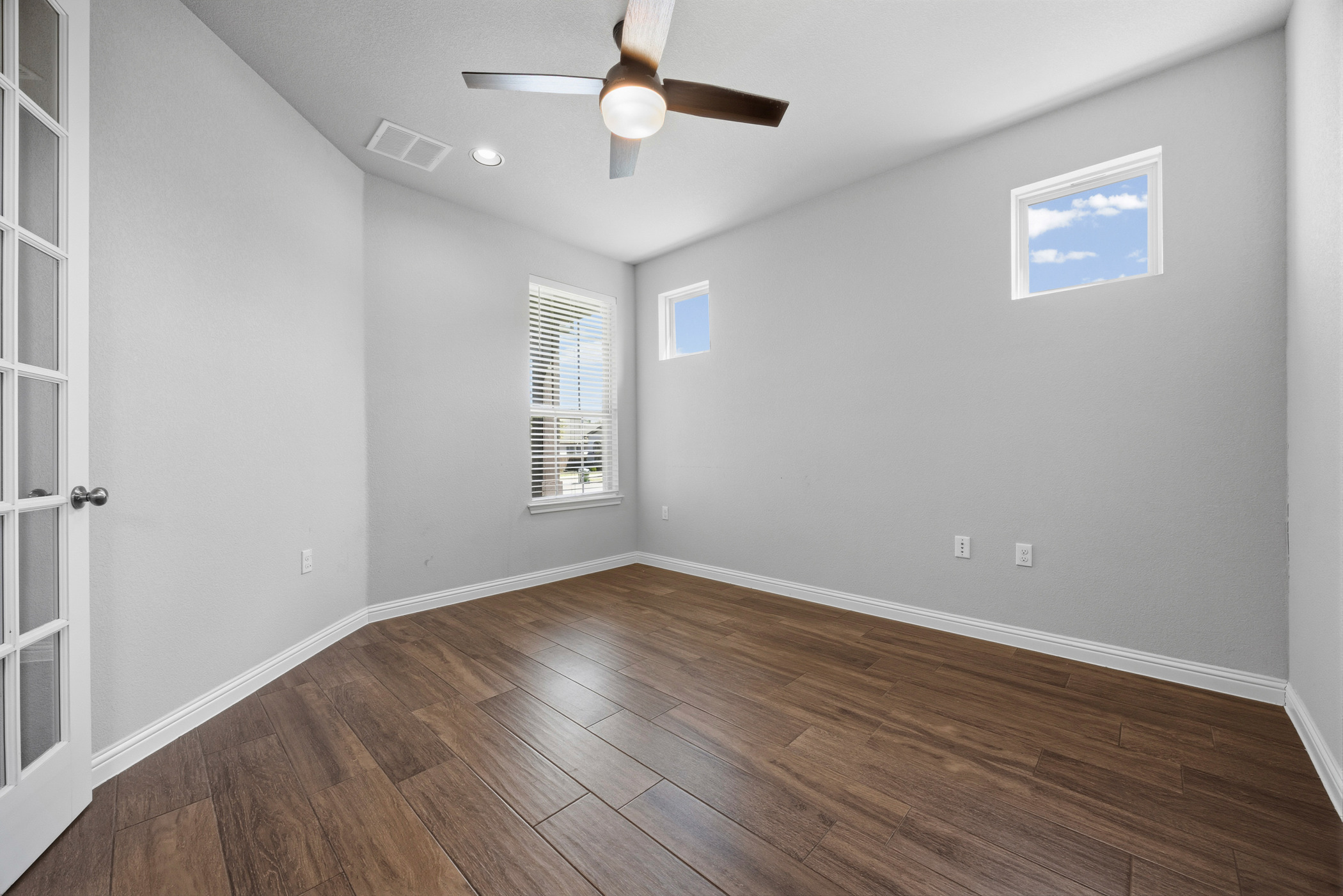 2209 Littleleaf Lane Leander, TX 78641 - Photo 9 of 27 Empty room featuring a ceiling fan, dark wood-type flooring, and recessed lighting