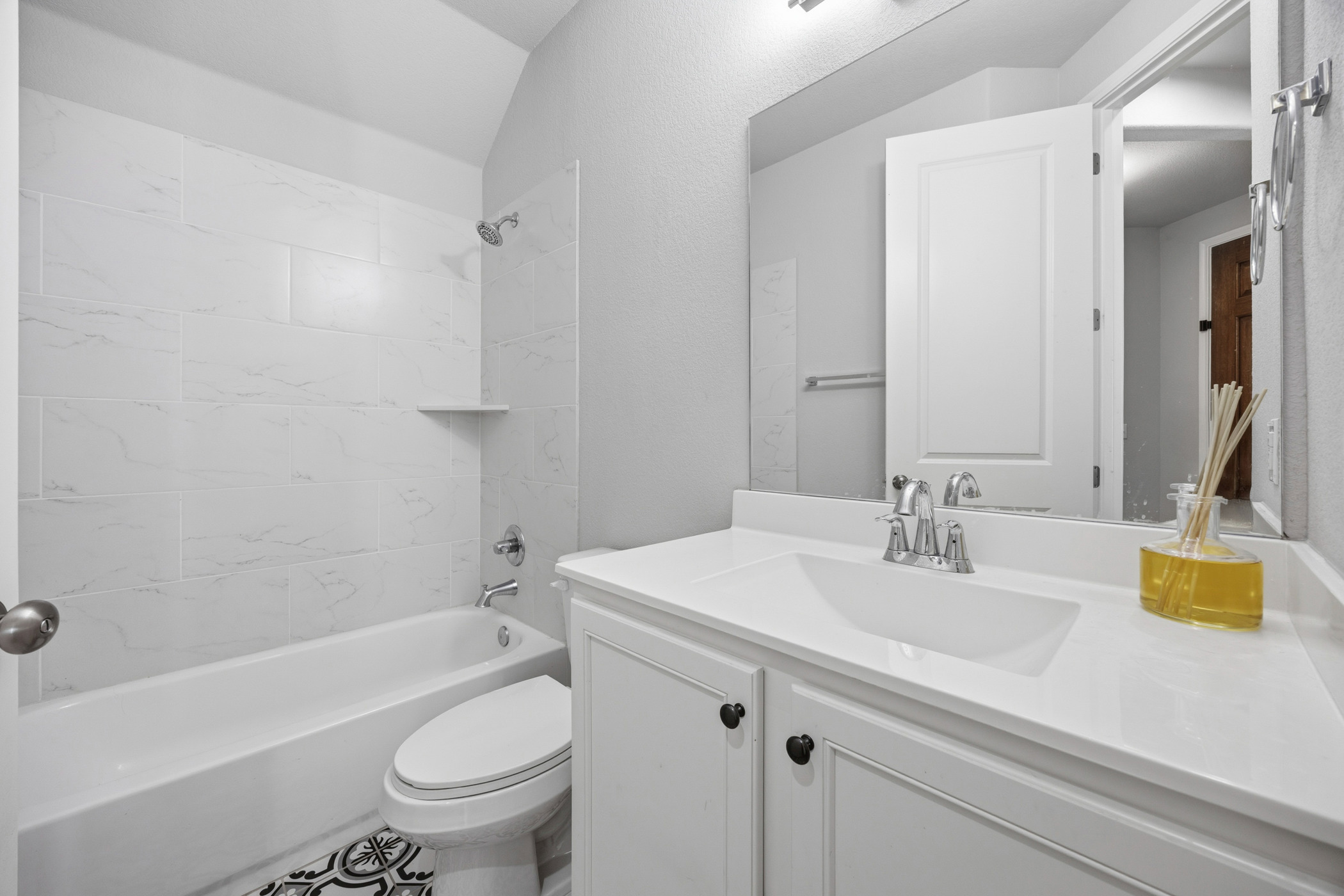 2209 Littleleaf Lane Leander, TX 78641 - Photo 10 of 27 Full bathroom with vanity, shower / washtub combination, and lofted ceiling