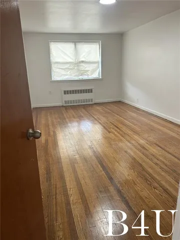 an empty room with wooden floor