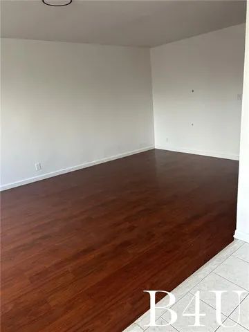 a view of room with wooden floor