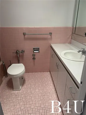 a bathroom with a sink a toilet and a mirror