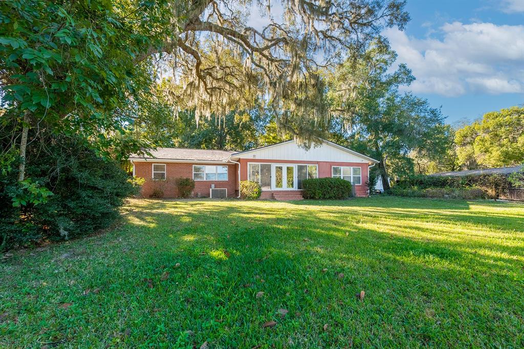 6306 Baker Road Keystone Heights, FL 32656 - Photo 13 of 53 a front view of a house with a garden
