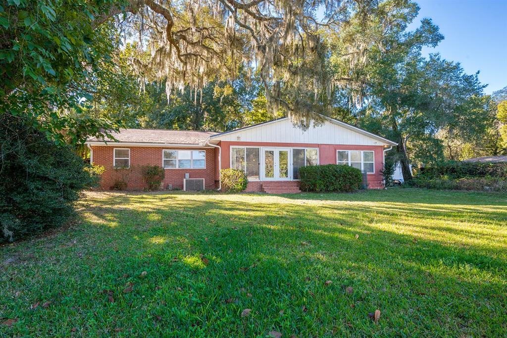6306 Baker Road Keystone Heights, FL 32656 - Photo 14 of 53 a front view of a house with a yard table and trees