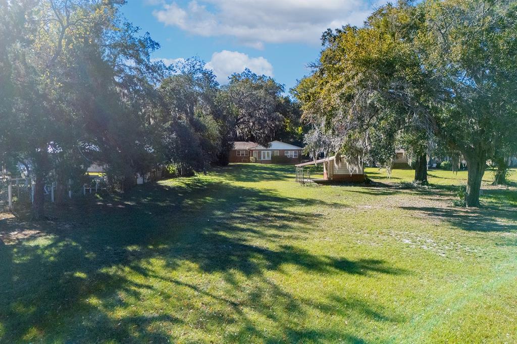 6306 Baker Road Keystone Heights, FL 32656 - Photo 26 of 53 a swimming pool with trees in the background