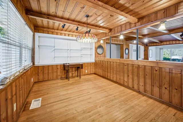 a living room with furniture a wooden floor and next to a window