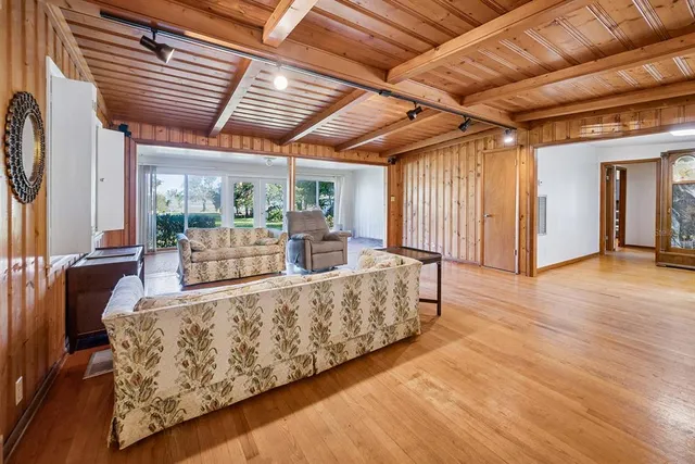 a view of livingroom with furniture and large window