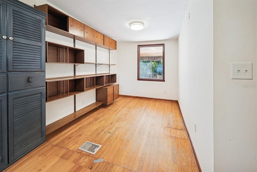 6306 Baker Road Keystone Heights, FL 32656 - Photo 46 of 53 a view of an empty room with wooden floor and a window