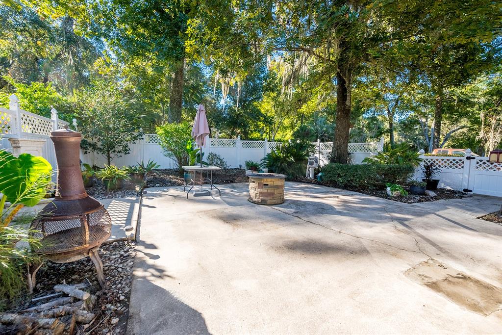 6306 Baker Road Keystone Heights, FL 32656 - Photo 8 of 53 a view of a backyard with potted plants and large trees