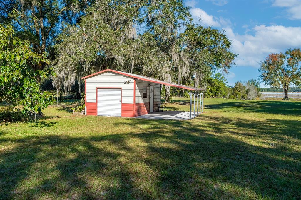 6306 Baker Road Keystone Heights, FL 32656 - Photo 10 of 53 a backyard of a house with lots of green space and fountain