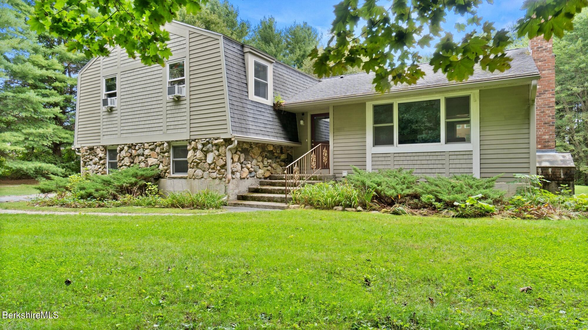 16 Squaw Peak Road Great Barrington, MA 01230 - Photo 2 of 38 a front view of a house with a yard and garden