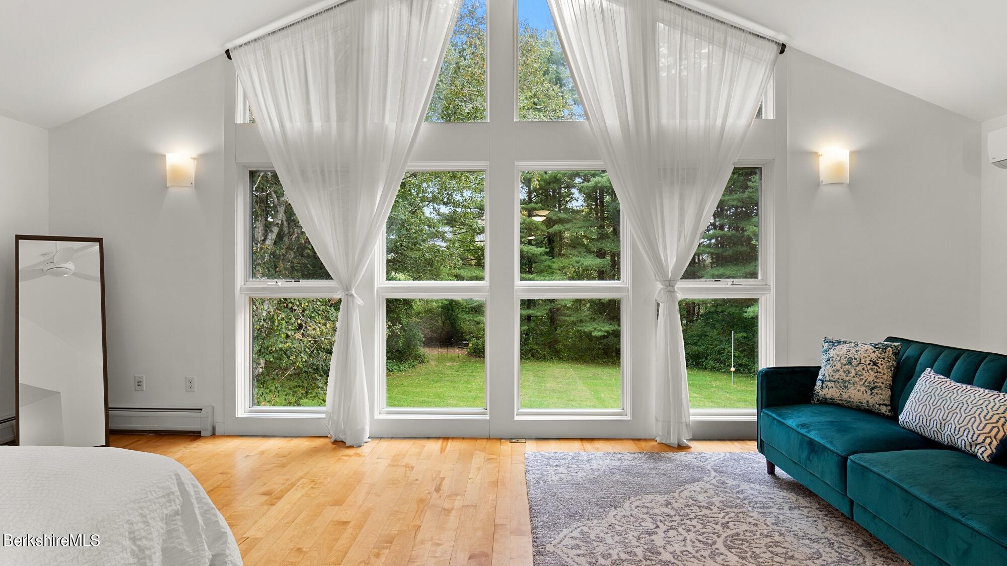 16 Squaw Peak Road Great Barrington, MA 01230 - Photo 20 of 38 a bedroom with furniture and a large window
