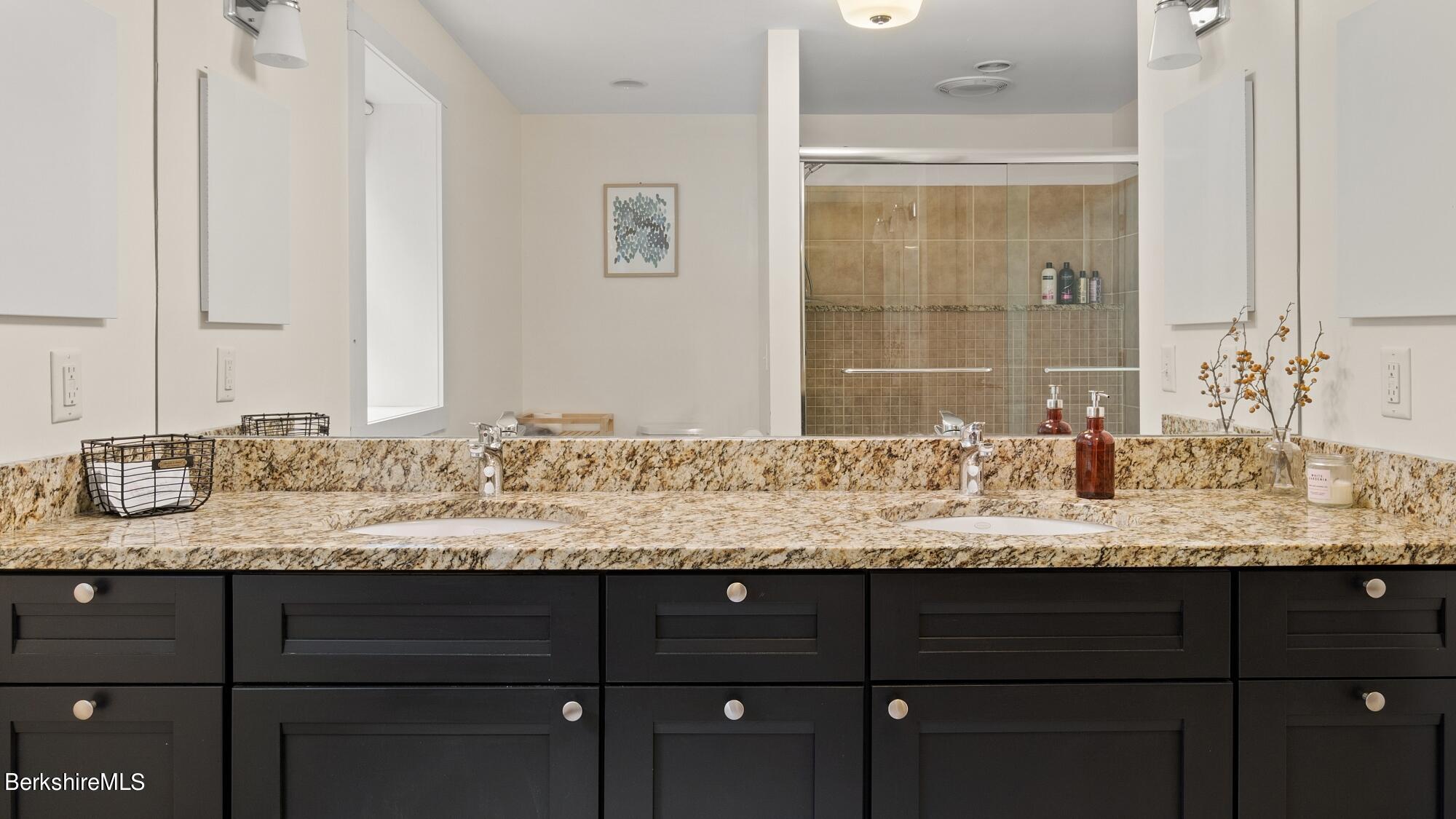16 Squaw Peak Road Great Barrington, MA 01230 - Photo 23 of 38 a bathroom with a granite countertop sink and a mirror
