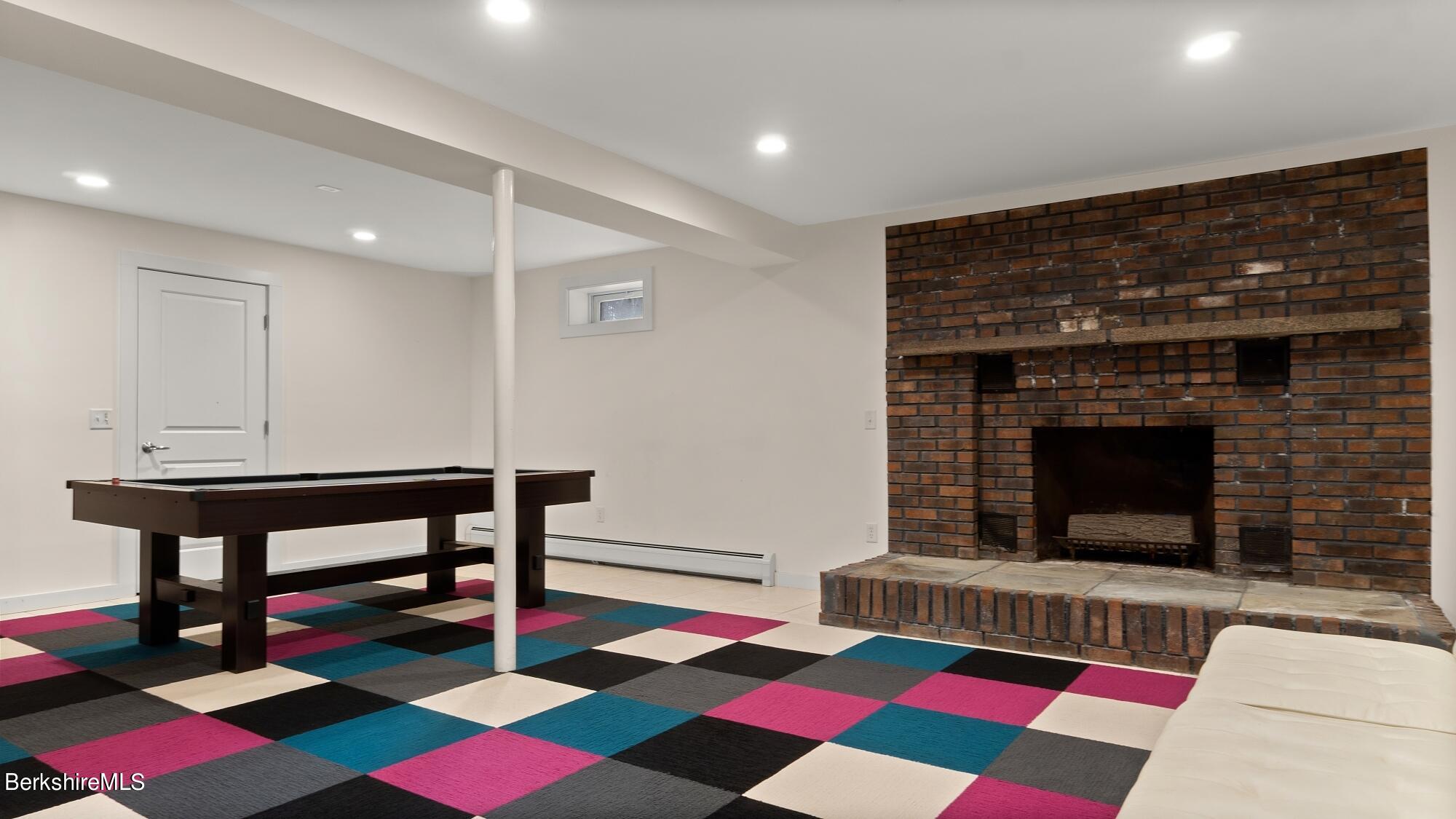 16 Squaw Peak Road Great Barrington, MA 01230 - Photo 32 of 38 a living room with a rug table and a fireplace