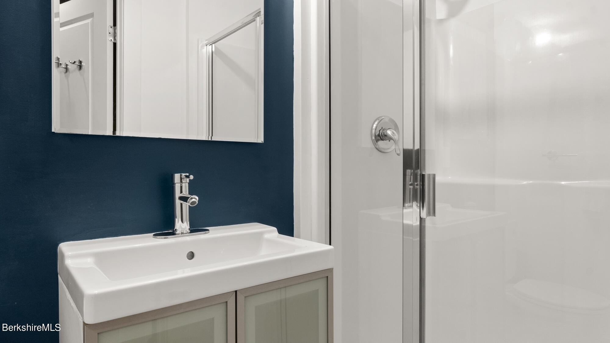 16 Squaw Peak Road Great Barrington, MA 01230 - Photo 33 of 38 a bathroom with a sink and a mirror