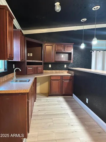 a kitchen with a sink stainless steel appliances and cabinets