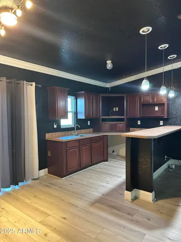 a bedroom with furniture and chandelier