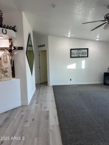 a view of a hallway with wooden floor