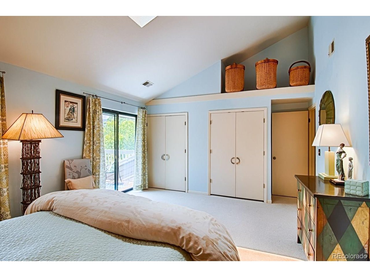 2948 Eagle Way Boulder, CO 80301 - Photo 19 of 29 a bedroom with a bed and a lamp on dresser