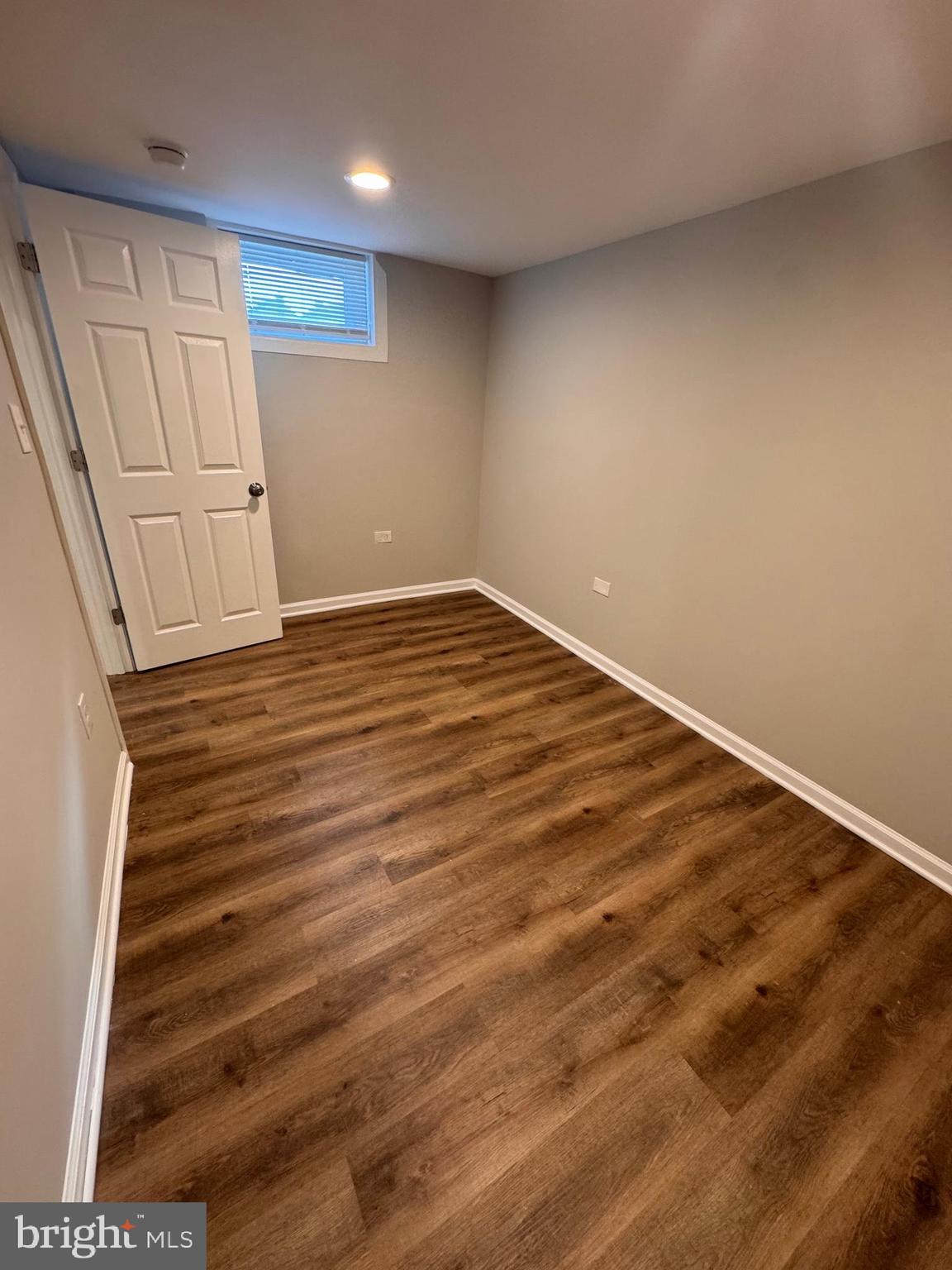 169 Hampshire Road Baltimore, MD 21221 - Photo 14 of 20 a view of empty room with wooden floor