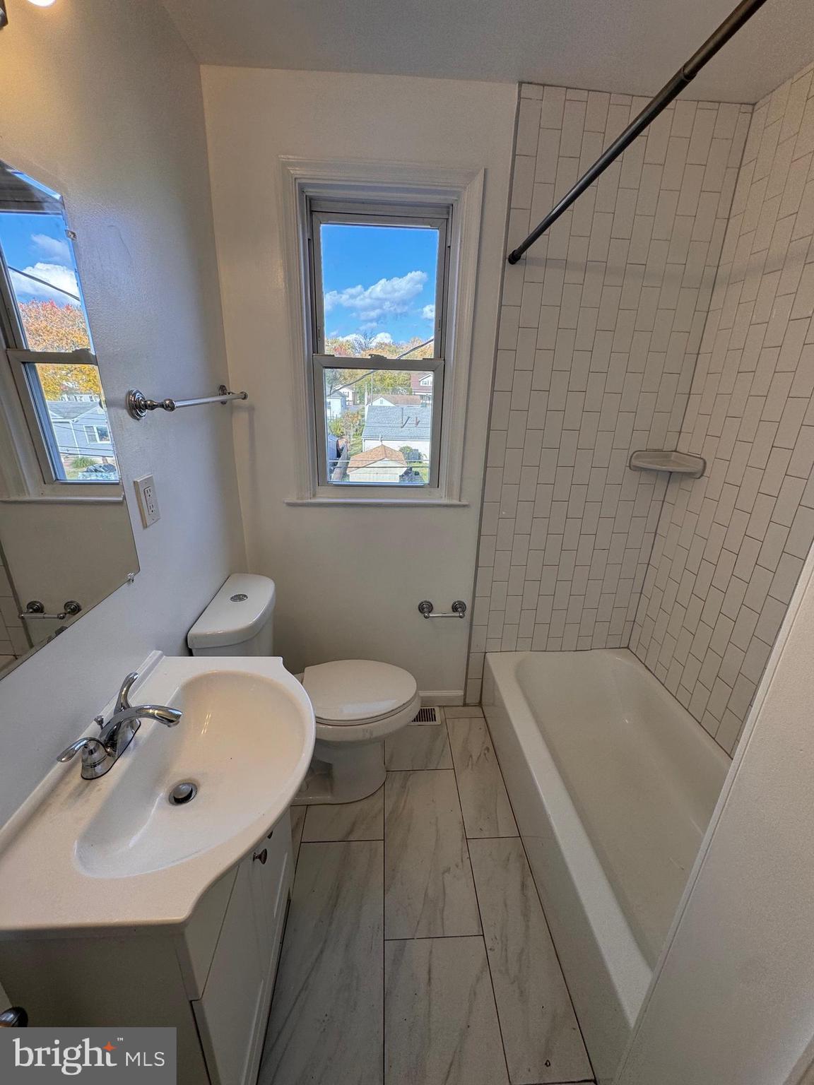 169 Hampshire Road Baltimore, MD 21221 - Photo 7 of 20 a bathroom with a sink a toilet and bathtub