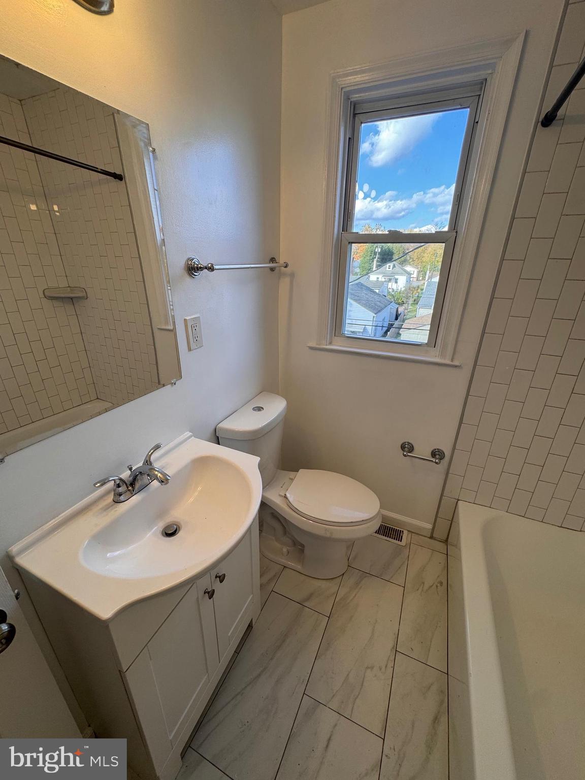 169 Hampshire Road Baltimore, MD 21221 - Photo 8 of 20 a bathroom with a sink and a mirror