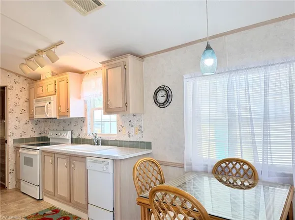 a kitchen with stainless steel appliances granite countertop a sink and a stove top oven