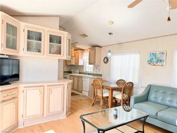 a living room with granite countertop furniture a dining table and kitchen view