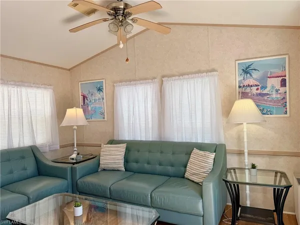 a living room with furniture and a lamp