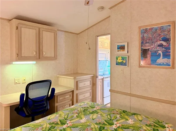 a bedroom with a chair and a dresser