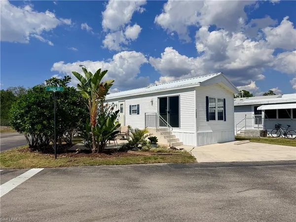 a view of a backyard with plants and a patio