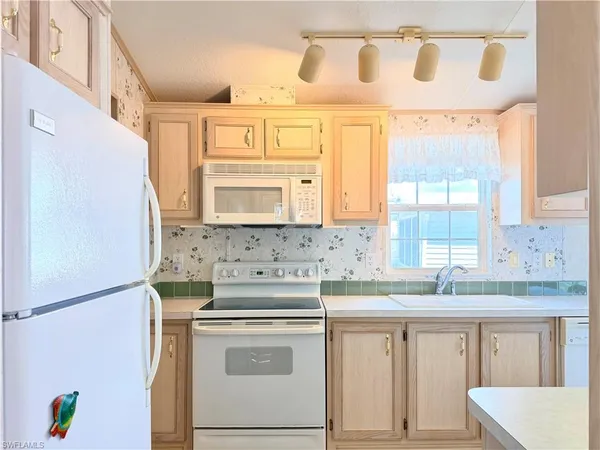 a kitchen with a stove a sink and a refrigerator