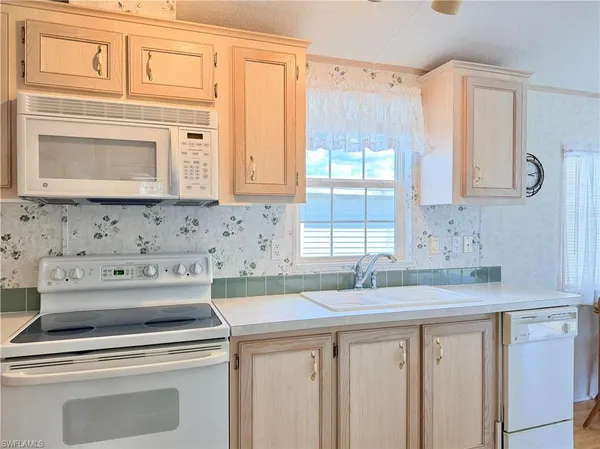 a kitchen with a sink cabinets and a window