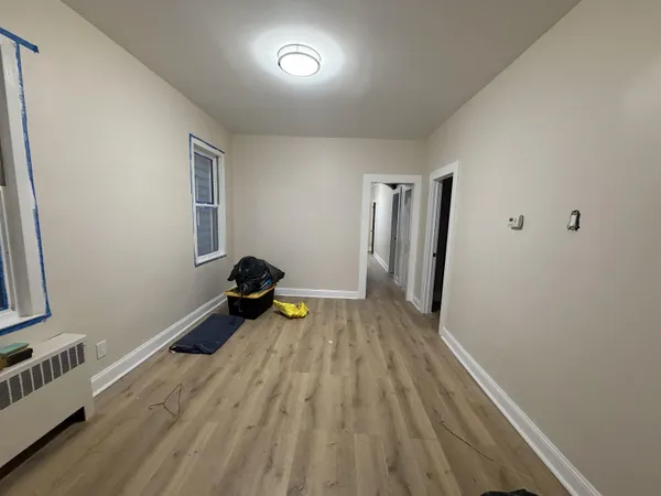 a view of a room with wooden floor and furniture