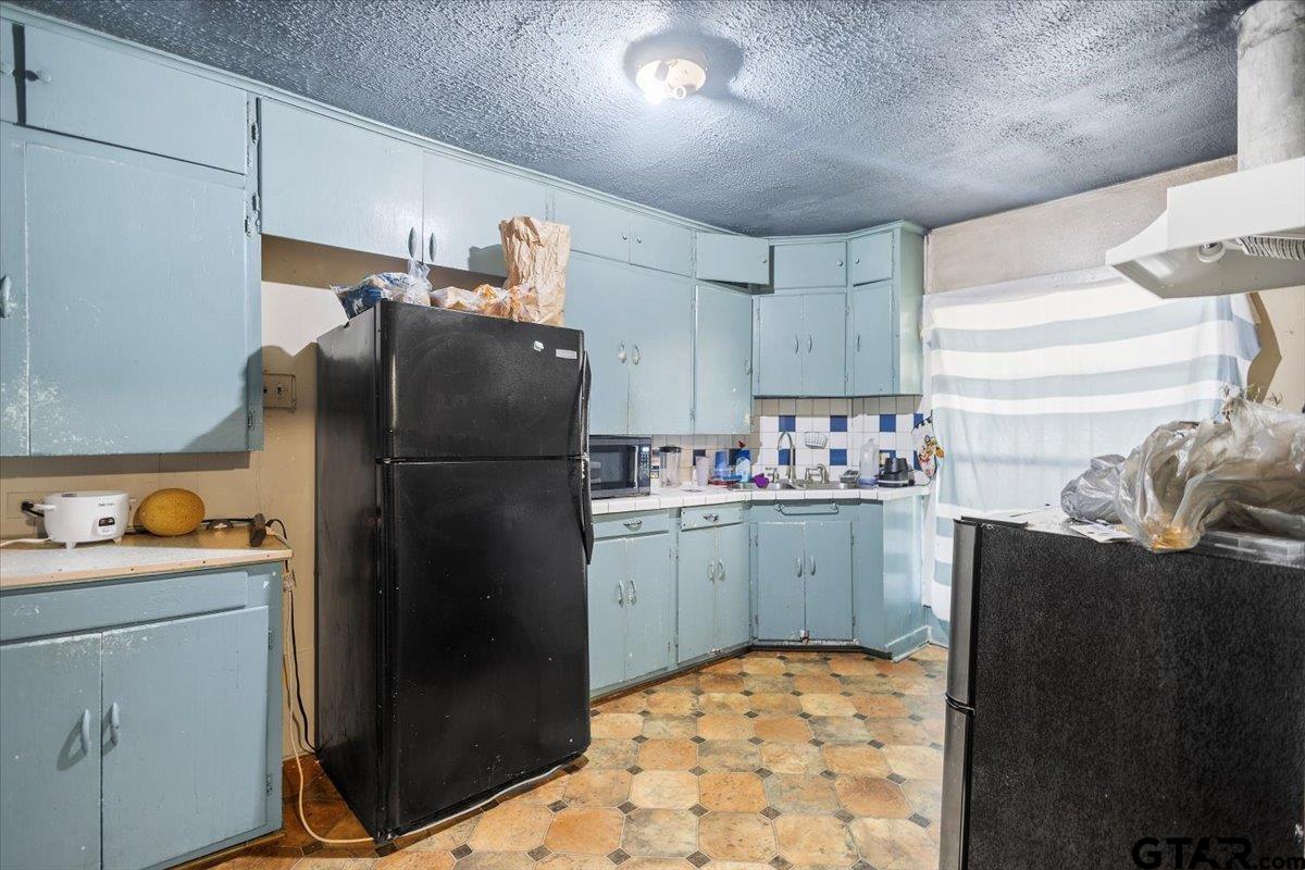 2516 Canton Street Tyler, TX 75702 - Photo 11 of 15 a kitchen with refrigerator and cabinets