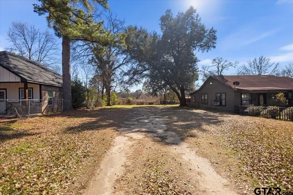a front view of a house with a yard covered in snow