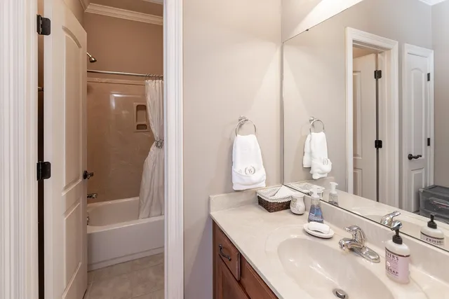 a kitchen with stainless steel appliances granite countertop a stove top oven a sink a dining table and chairs with the cabinets