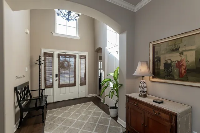 a living room with furniture and a mirror