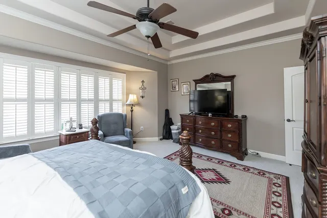 a view of a hallway with workspace and a window
