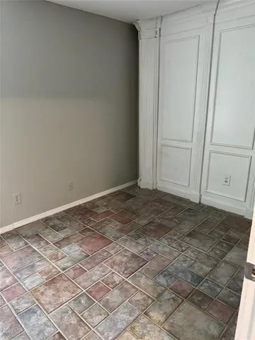 a white toilet sitting next to a shower