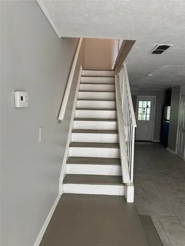 a view of staircase with white walls and windows