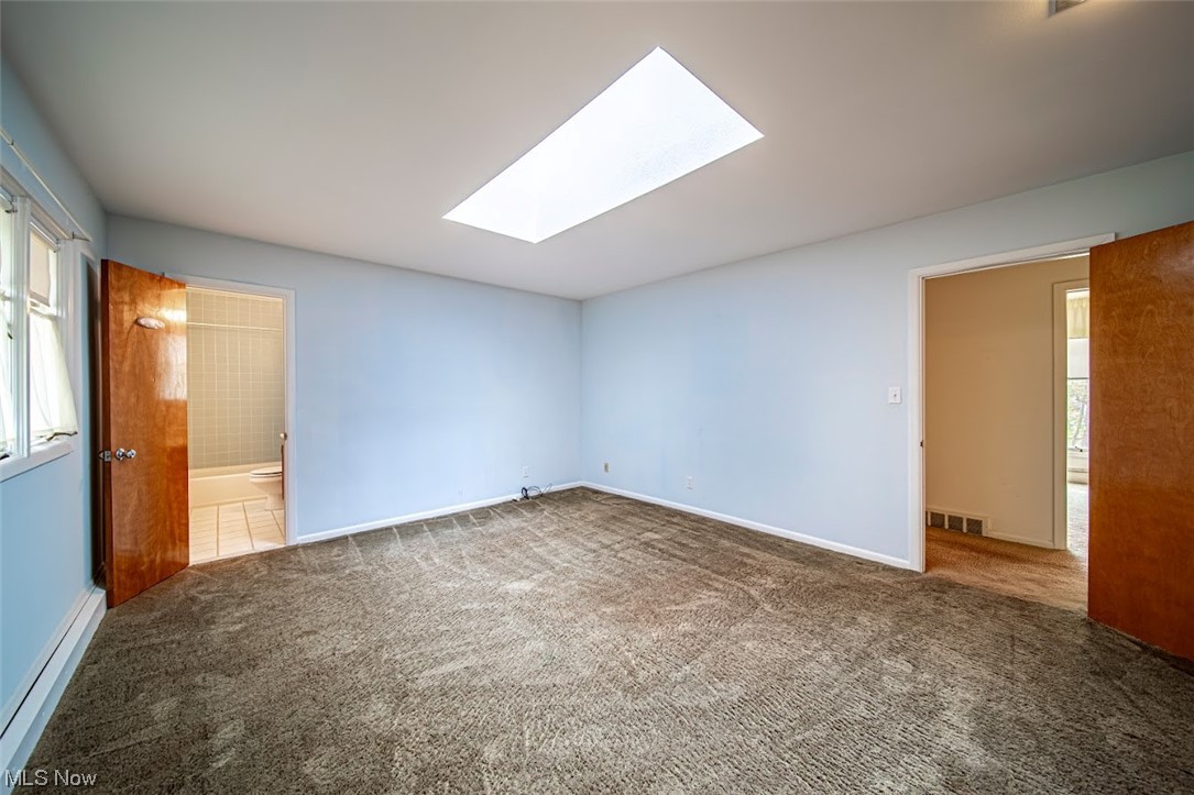 2323 Rockefeller Road Wickliffe, OH 44092 - Photo 17 of 34 Spare room featuring carpet flooring and a skylight
