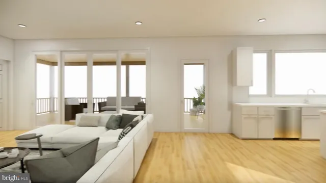 a view of a hallway with wooden floor and windows