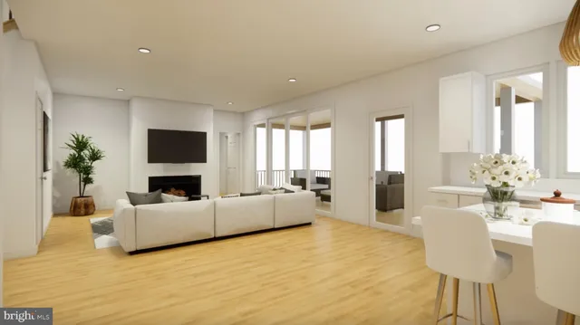 a view of a bedroom with furniture and wooden floor