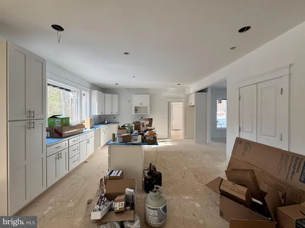 a kitchen with granite countertop a sink stove and cabinets
