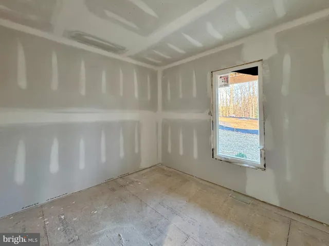 a view of empty room with a fireplace